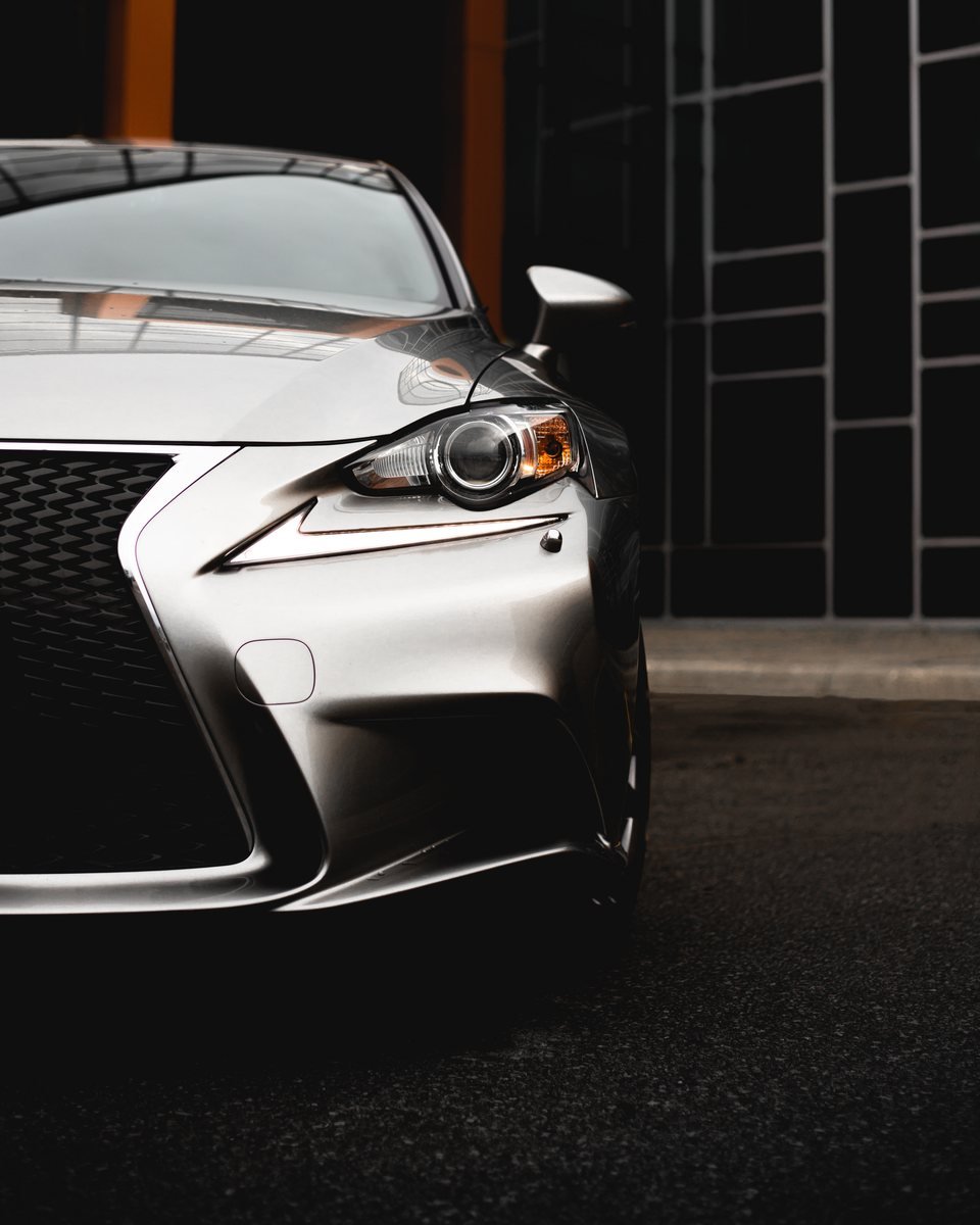Front bumper, bonnet edge and headlight of a silver sedan, the panels most exposed to stone chips
