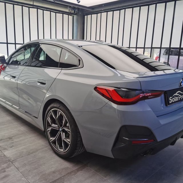 Grey gran coupe finished in SolarPro clear PPF inside an install bay