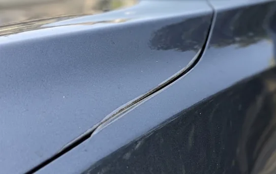 Close-up of a paint protection film edge on a car panel
