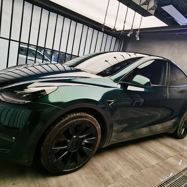 Dark green crossover under the light boxes of an install bay