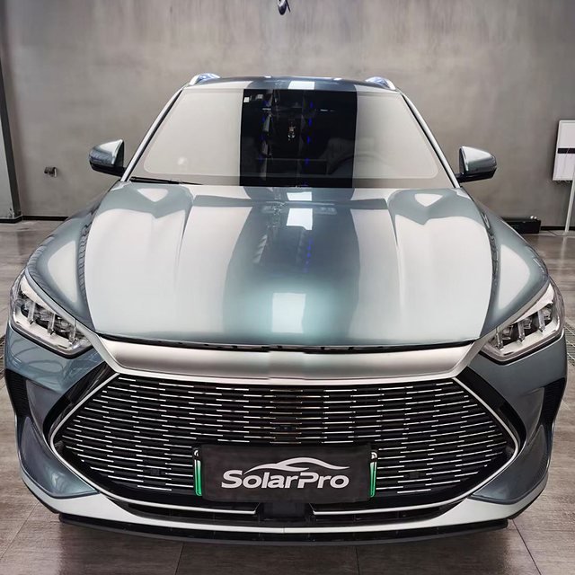 Teal-grey SUV seen from the front with a SolarPro plate