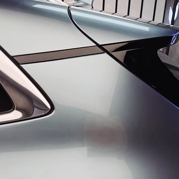 Close-up of a panel edge on the rear quarter of a grey car
