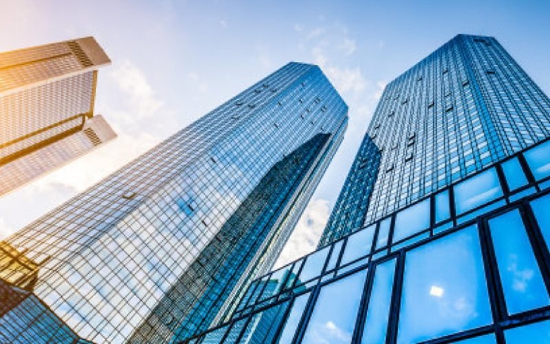 Glass curtain-wall towers seen from street level