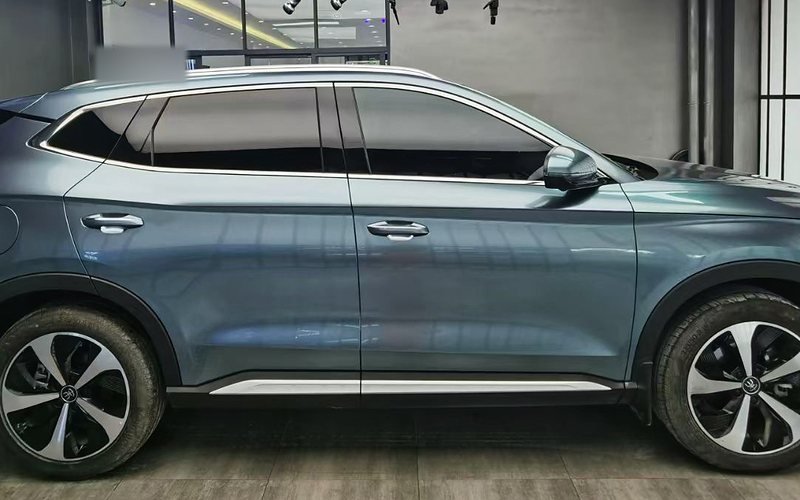 Blue-grey SUV with tinted side windows in an install bay
