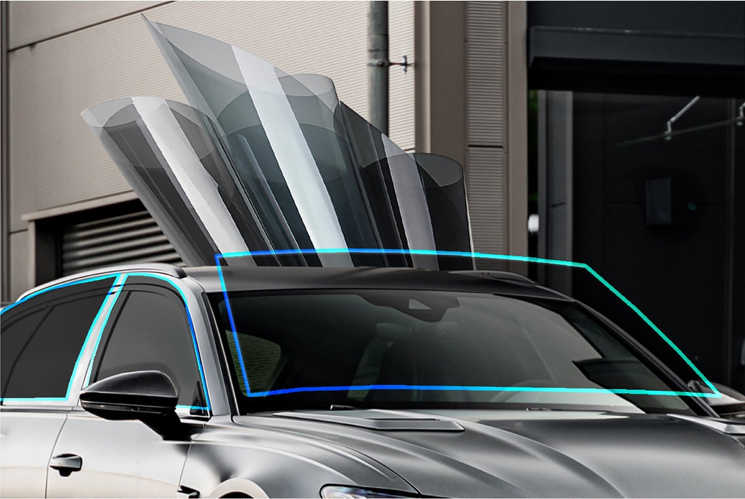 Dyed window tint samples fanned out from light to dark shades above a car windscreen