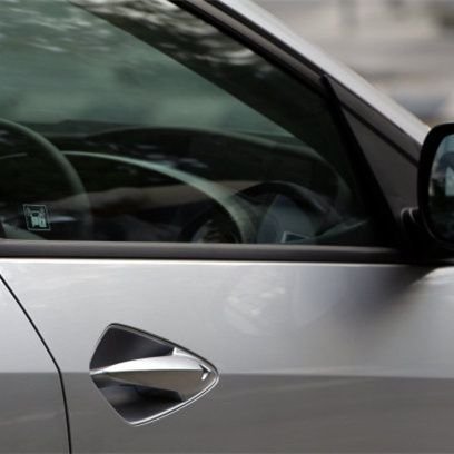 Side glass with dyed automotive tint film