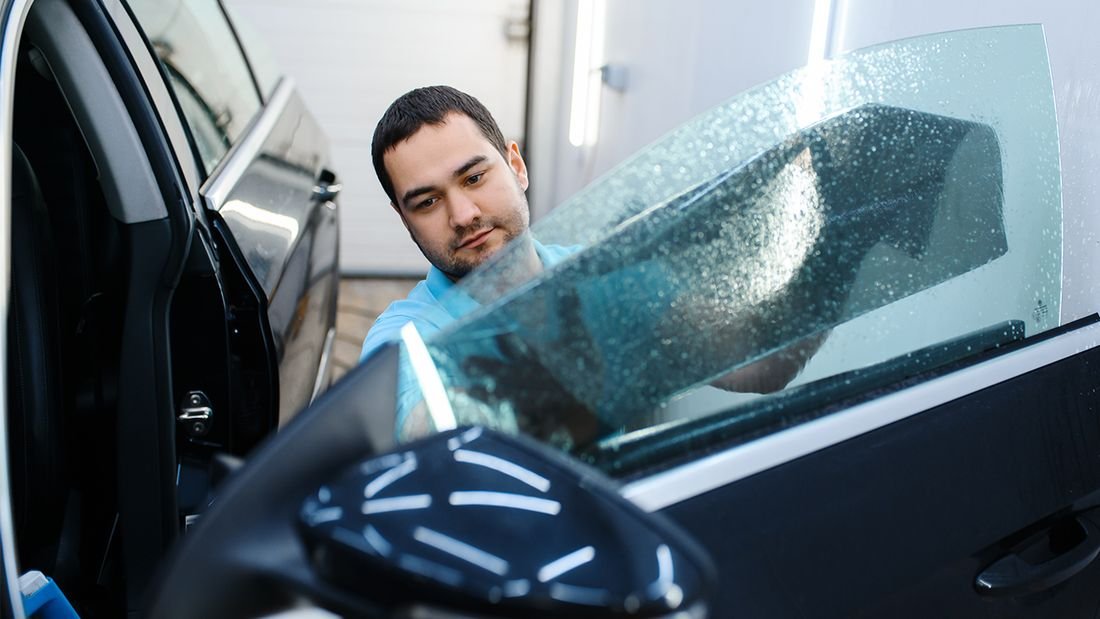 Installer handling cut film before application