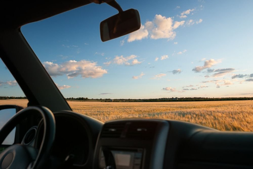 View through a windscreen on a sunlit road